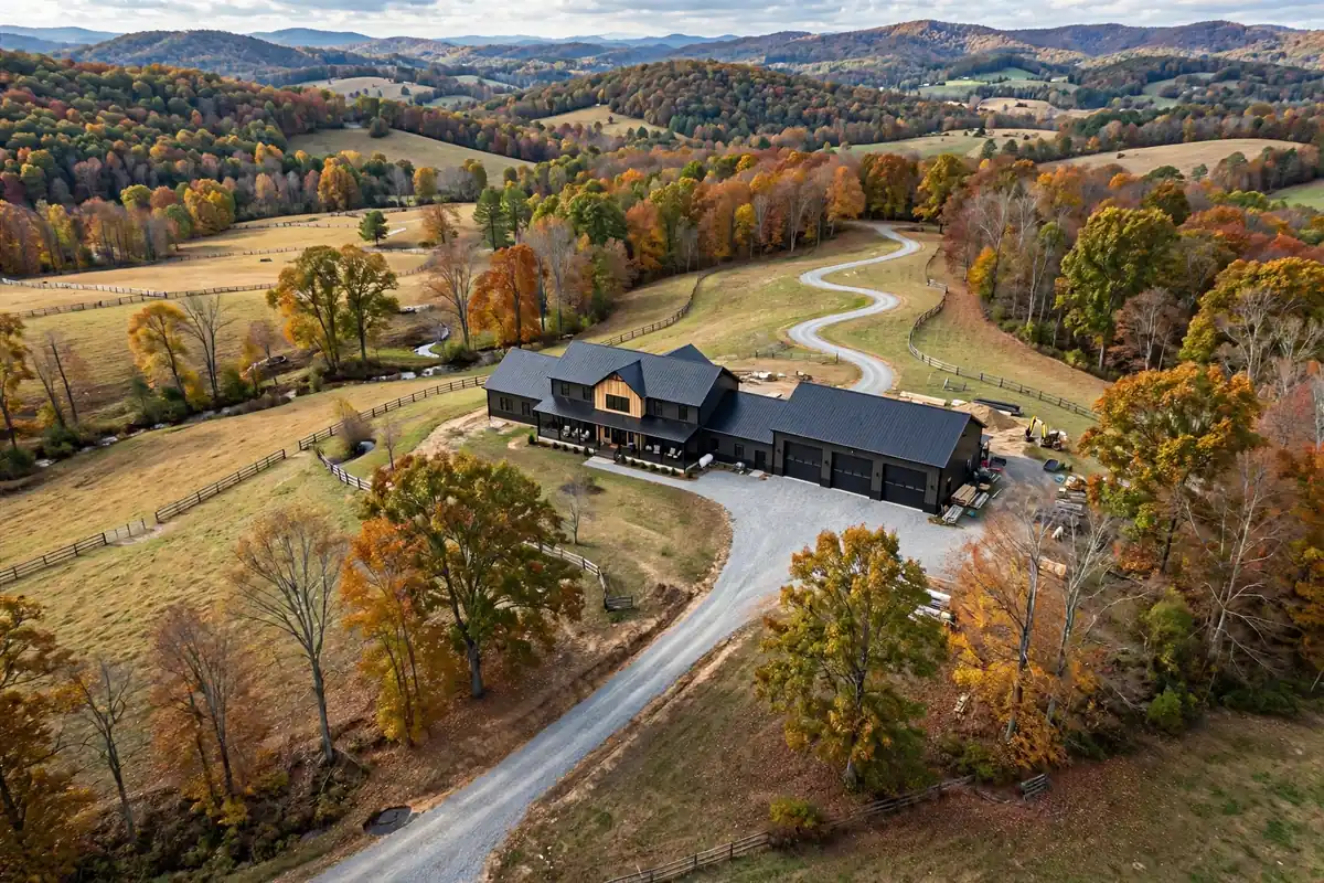 Aerial view of a Virginia barndominium with an attached shop, garage, and long driveway — layout affecting Barndominium Cost Per Sqft in Virginia